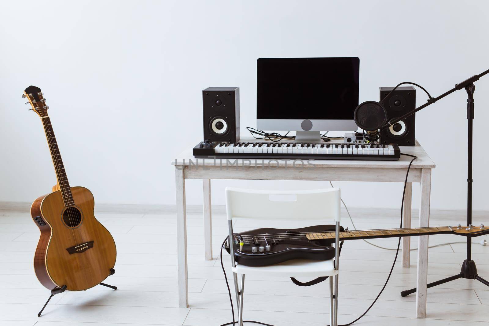 Microphone, computer and musical equipment guitars and piano background. Home recording studio concept. by Satura86
