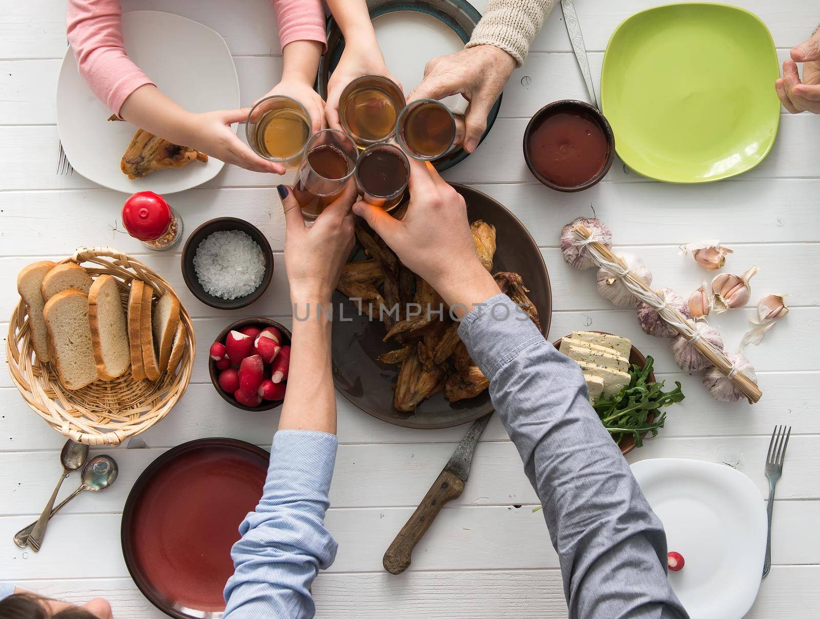 people having meal and clinking glasses top view