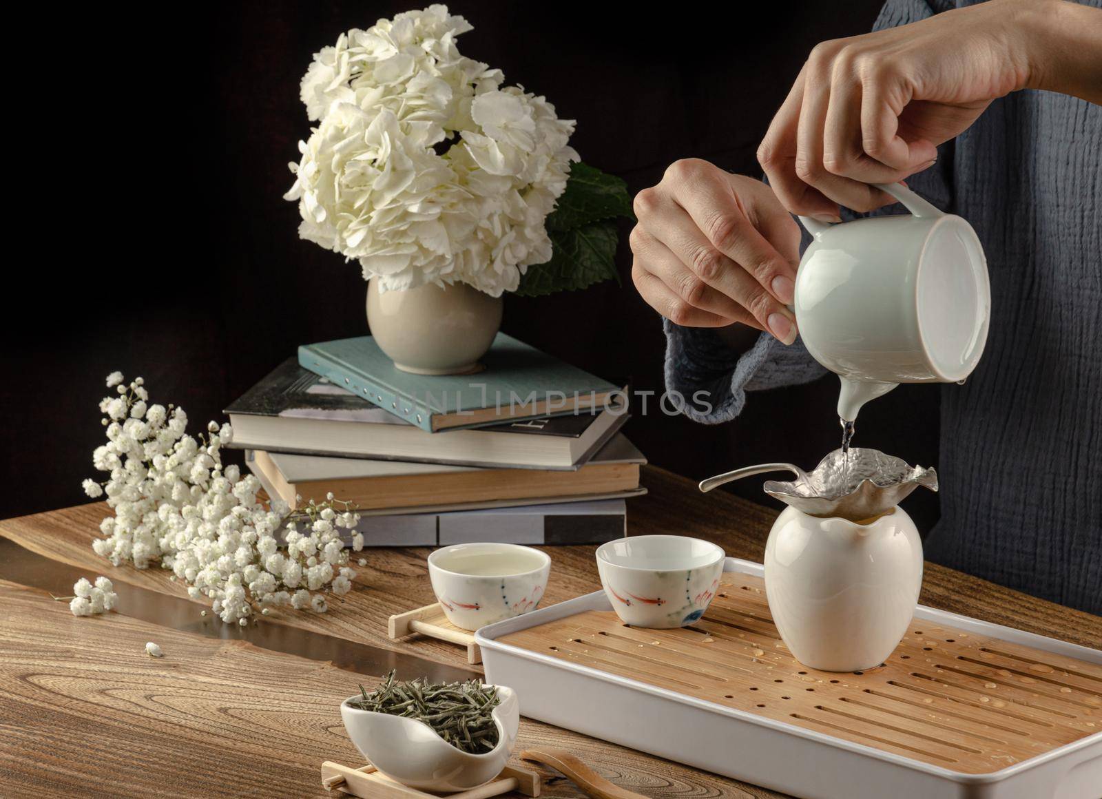 tea table with instruments teapots cups and green tea cooking process