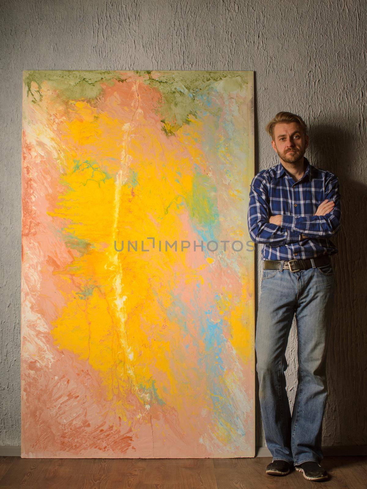 Portrait Of Male Artist standing next to his abstract painting in the Studio by zartarn