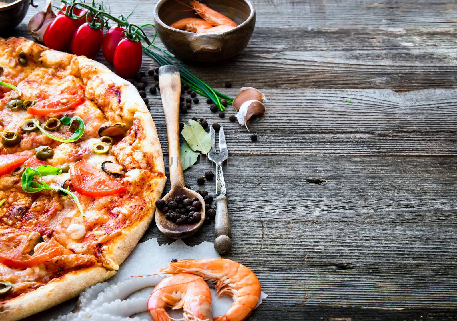 delicious pizza with seafood on wooden table