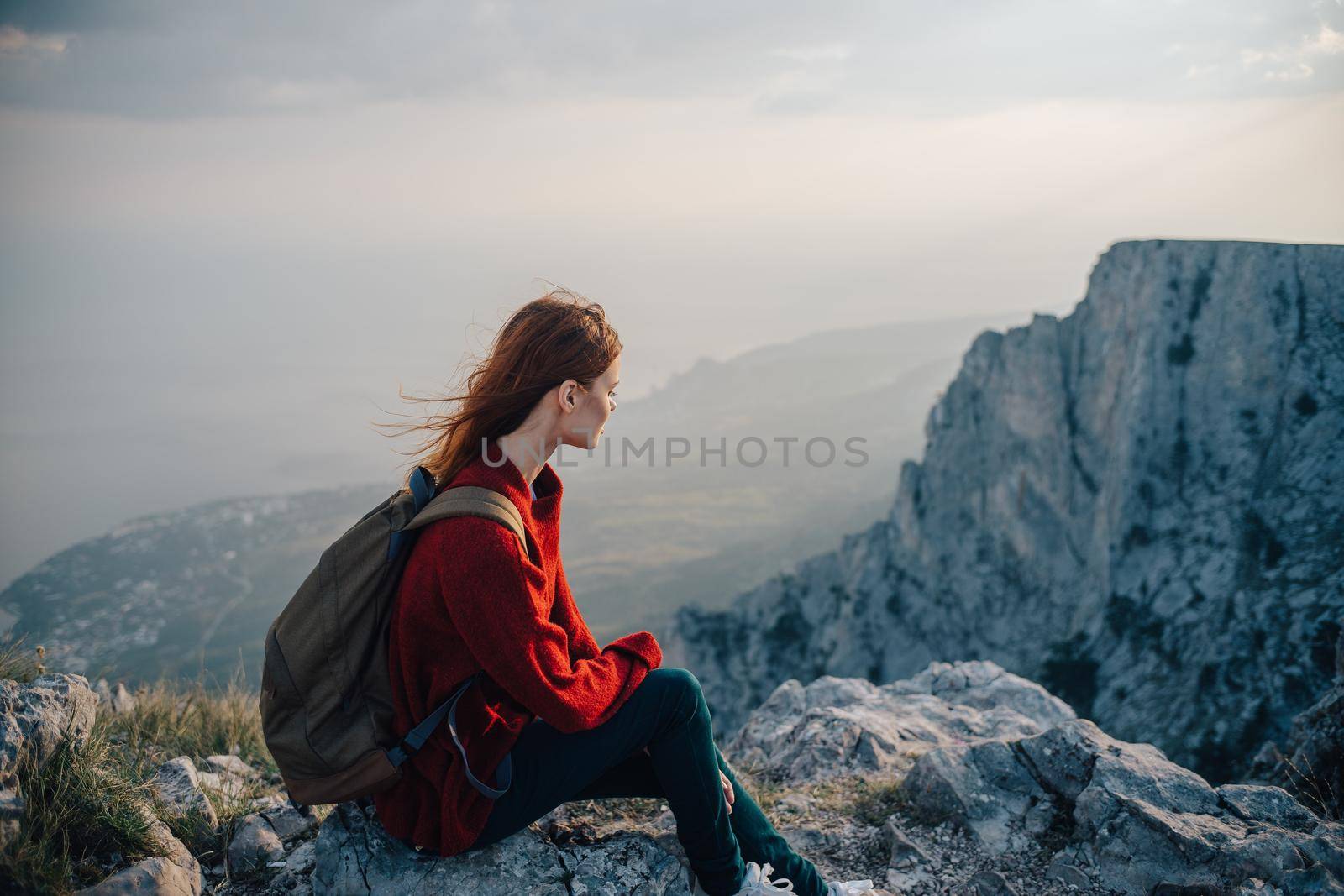 woman with backpack in mountains at altitude landscape nature. High quality photo