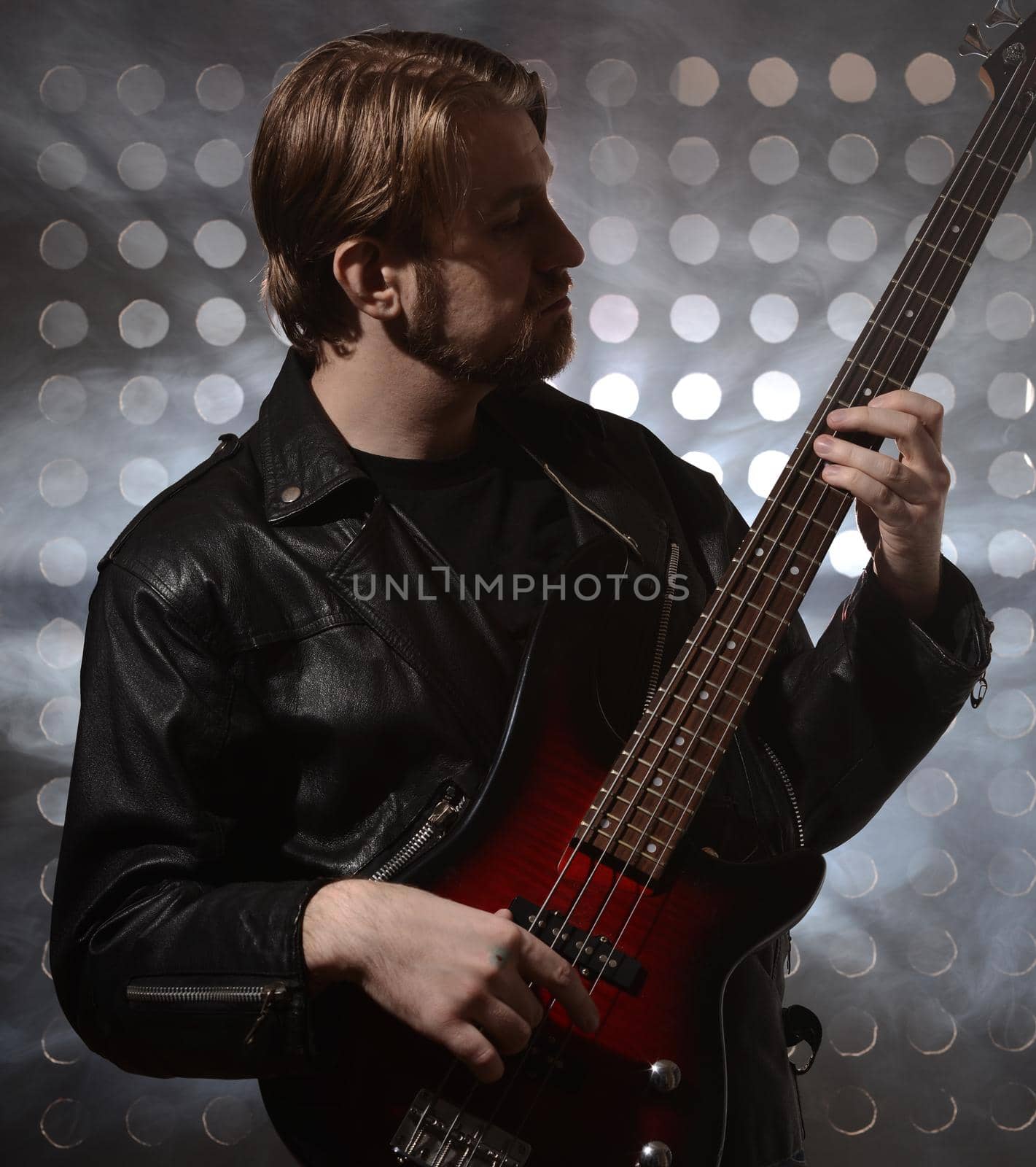 bassist playing a custom made bass guitar