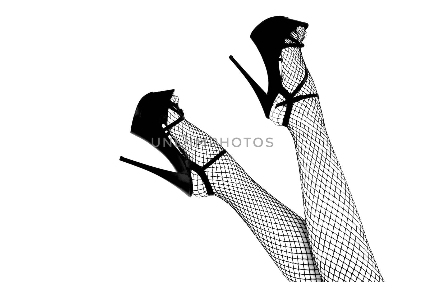 Sexy female legs in high heel red striptease shoes and fishnet stockings. - image