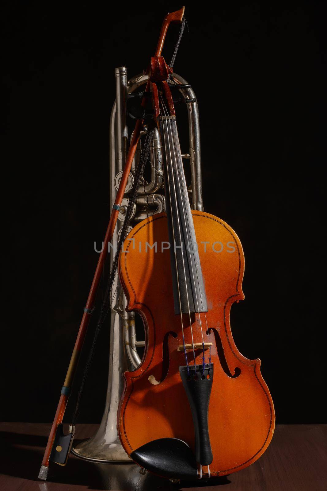 Old violin bow and broken pipe on a black background by zartarn