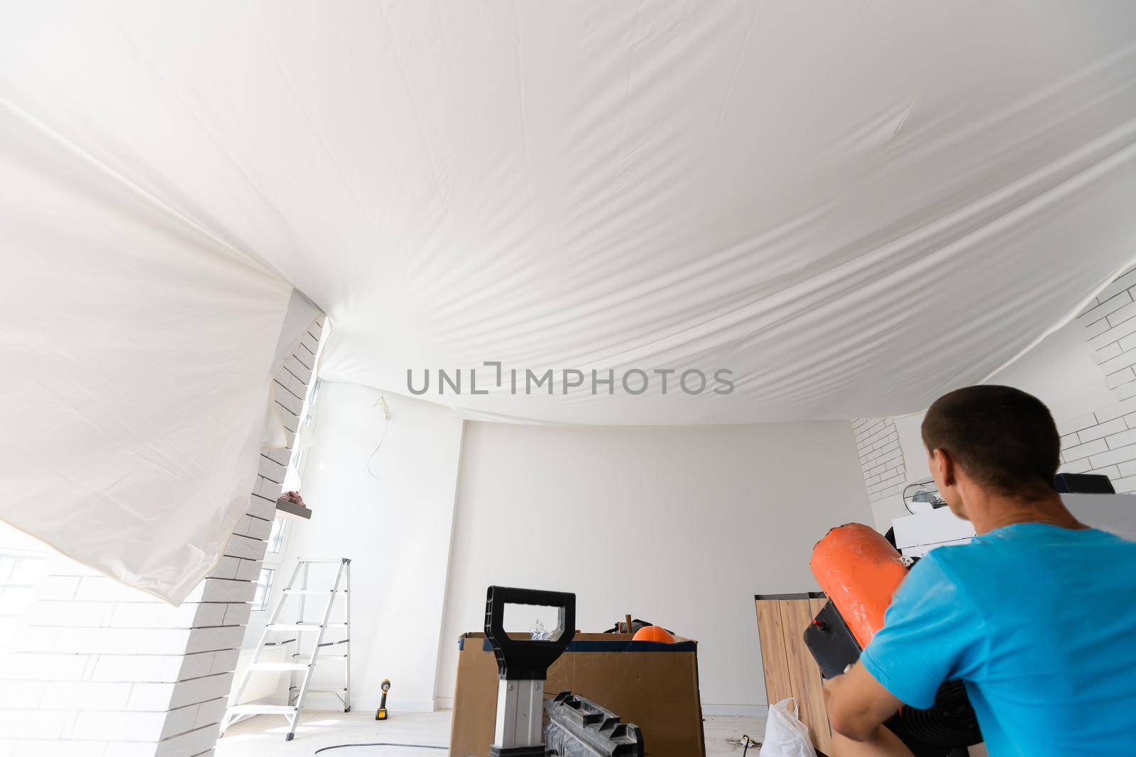 Stretch ceiling in the kitchen with installed and included spotlights