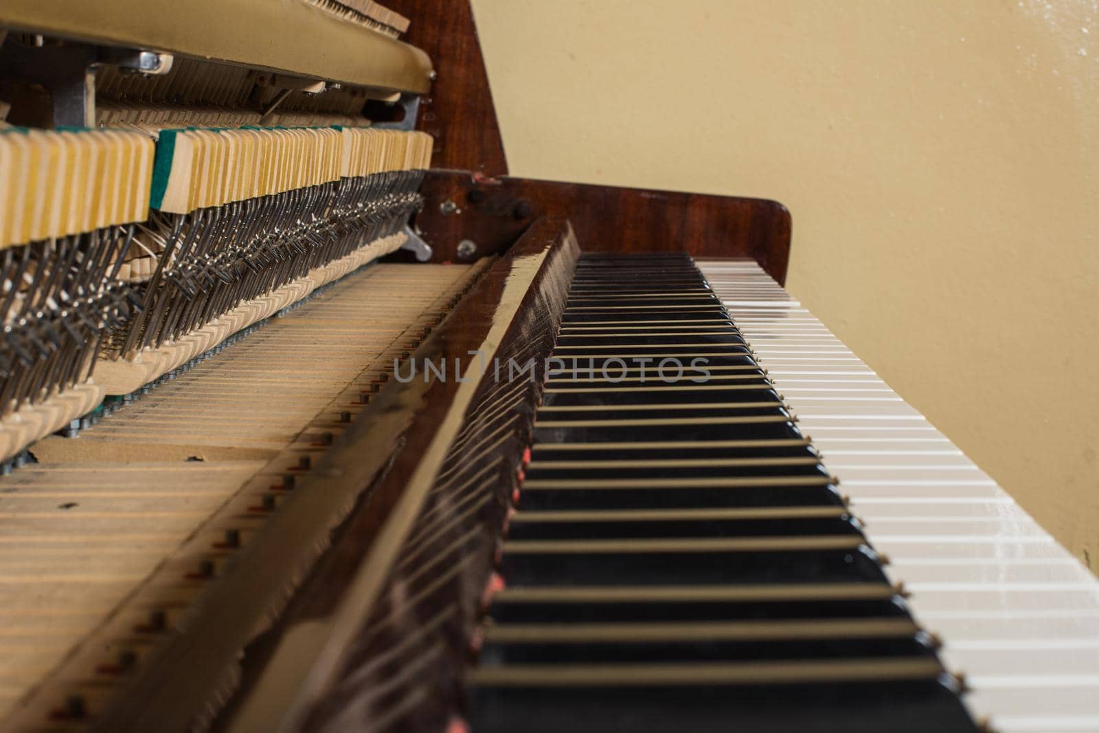 Piano keyboard background with selective focus. Warm color toned image