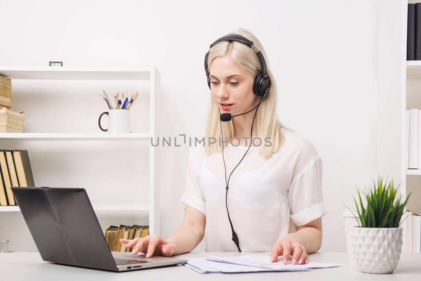 Close-up portrait of a customer service agent sitting at office by zartarn