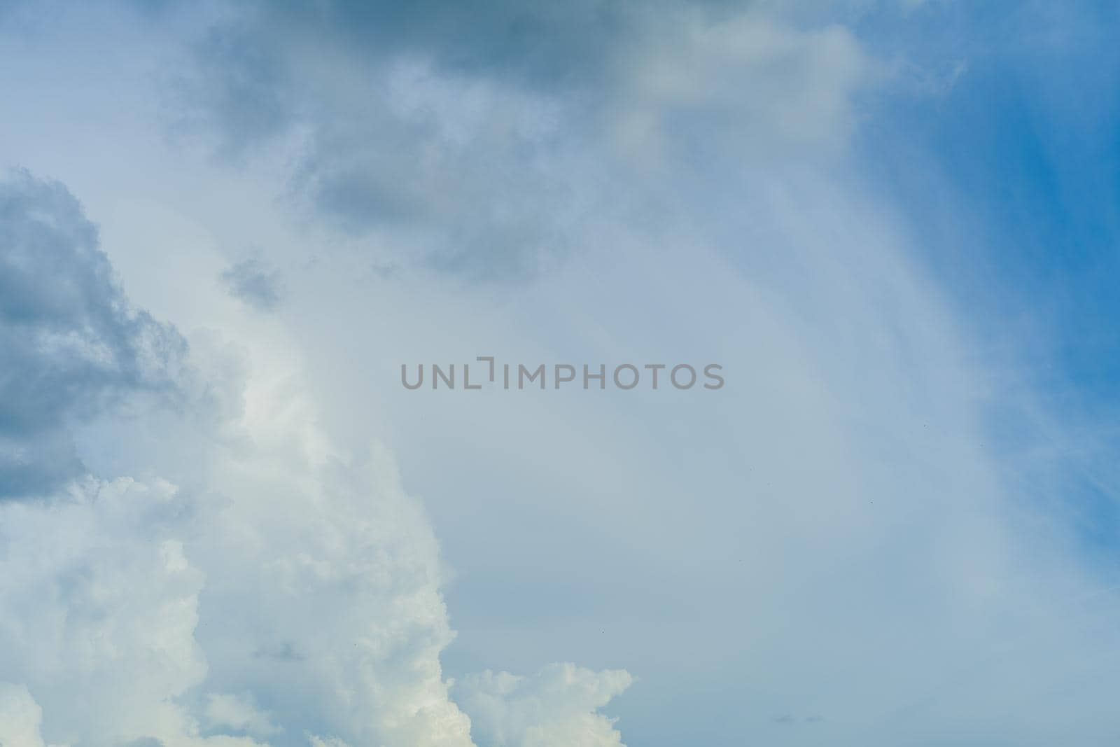 Blue sky background with white fluffy clouds - image