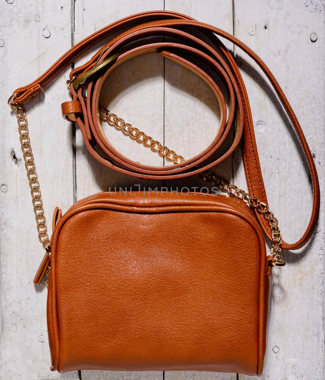 woman bag and belt on wooden background