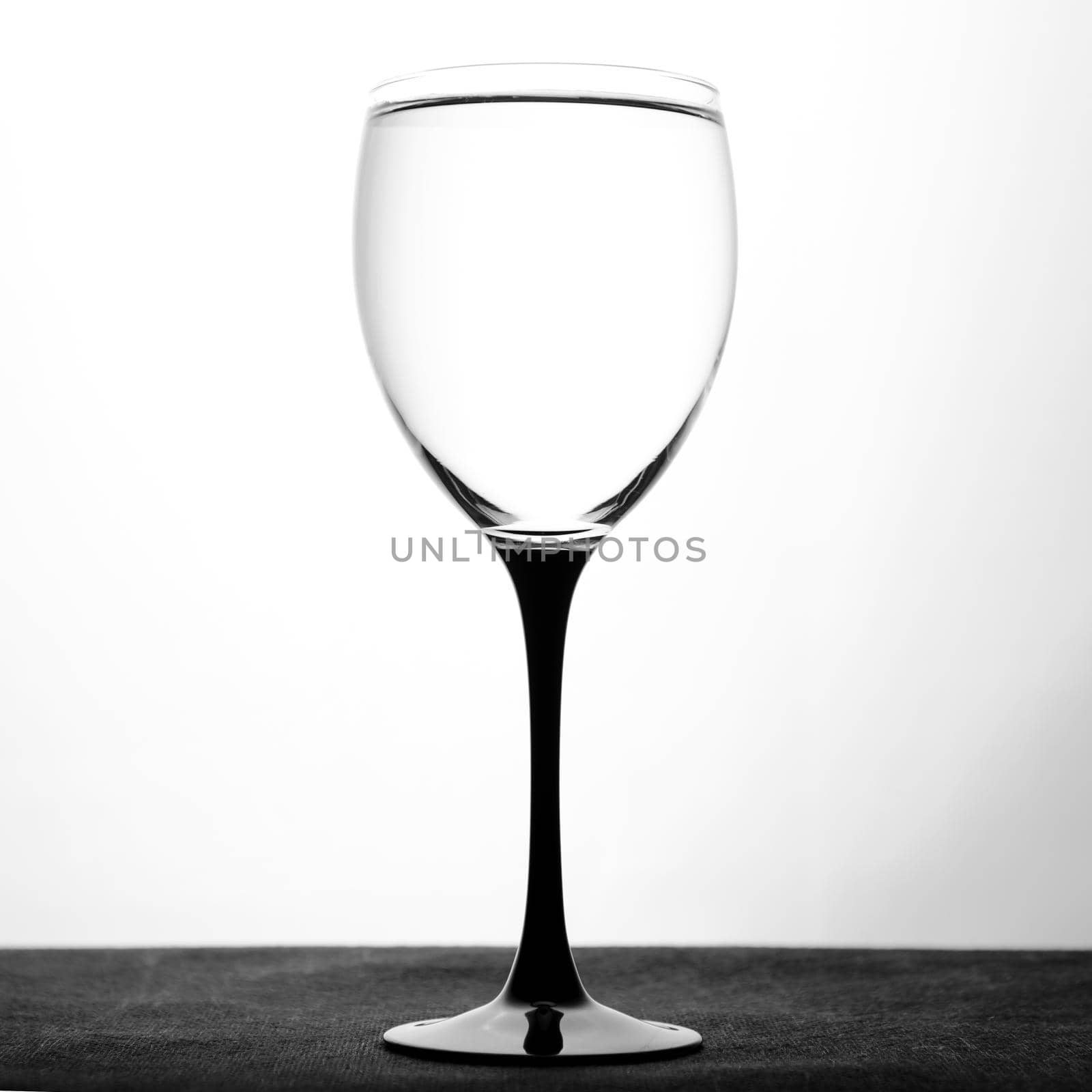 Wine glass with water on white background.