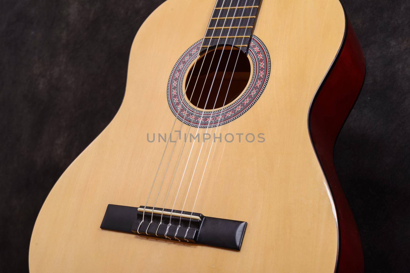 Acoustic classical guitar. Close-up deck and strings.