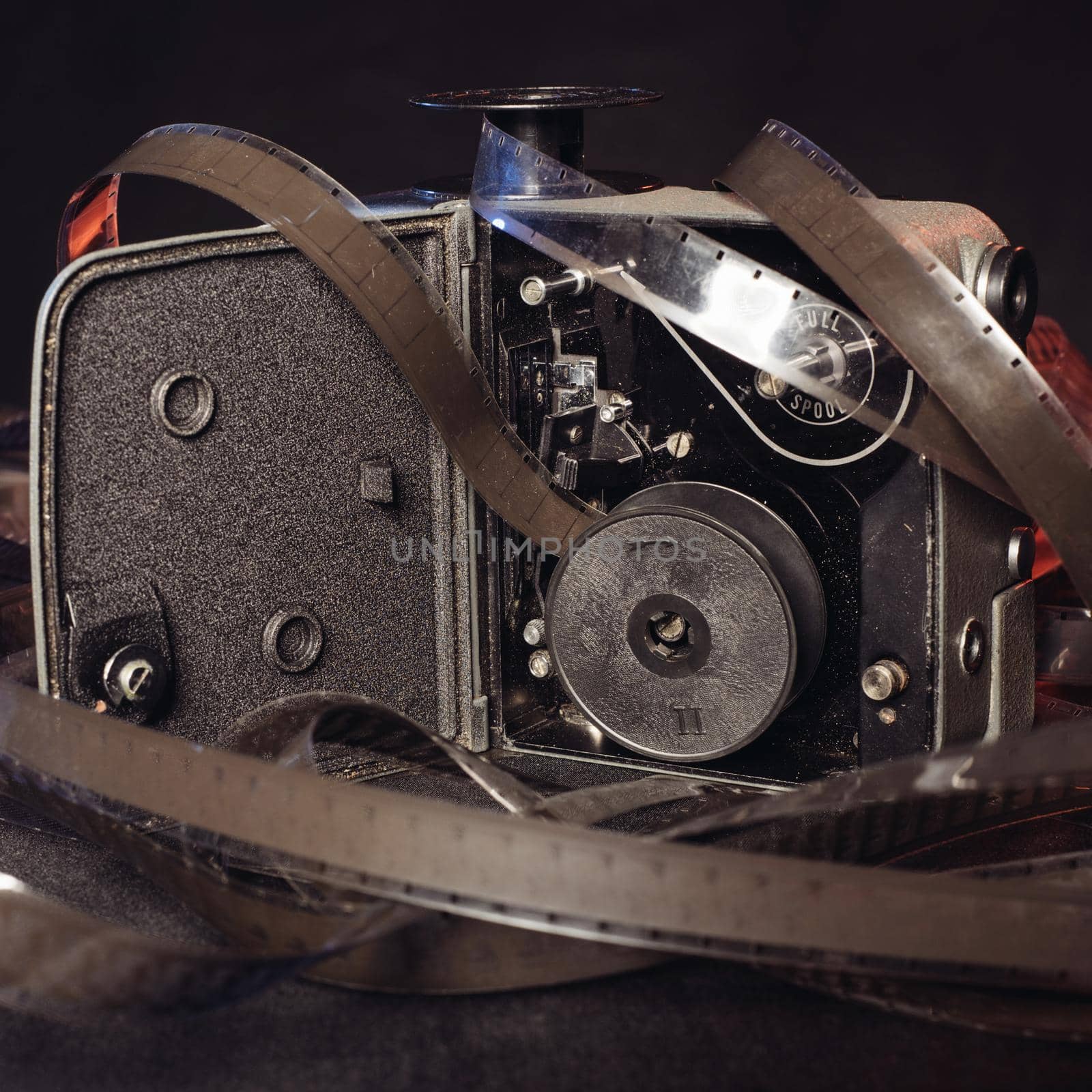 close-up of an old film and the insides of a vintage movie camera on the table.