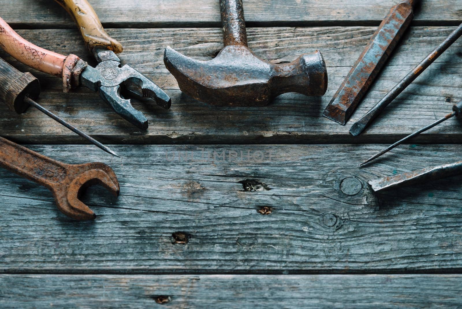 Set of old working tools on wooden background, space for text