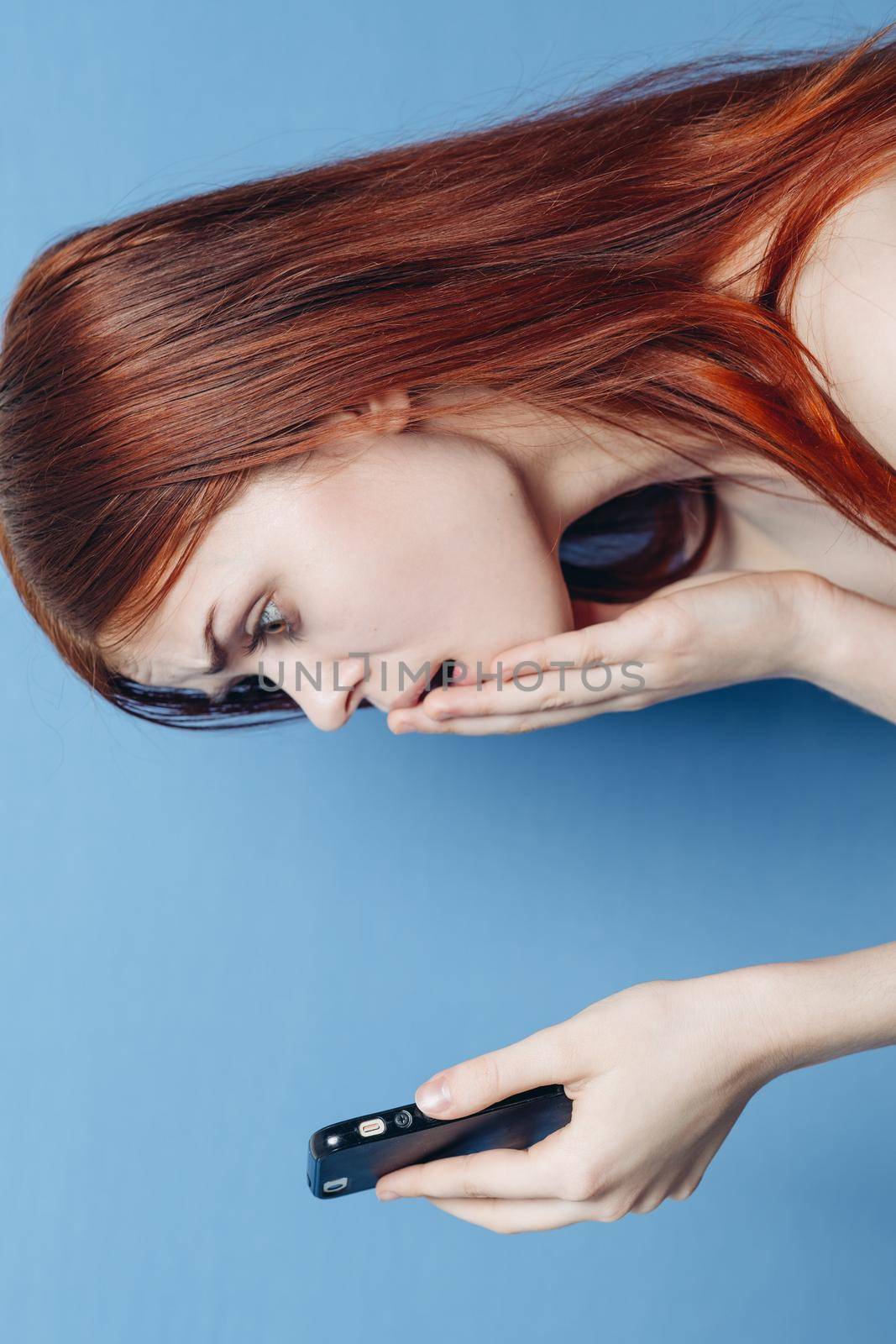 woman with red hair bare shoulders talking on the phone by Vichizh