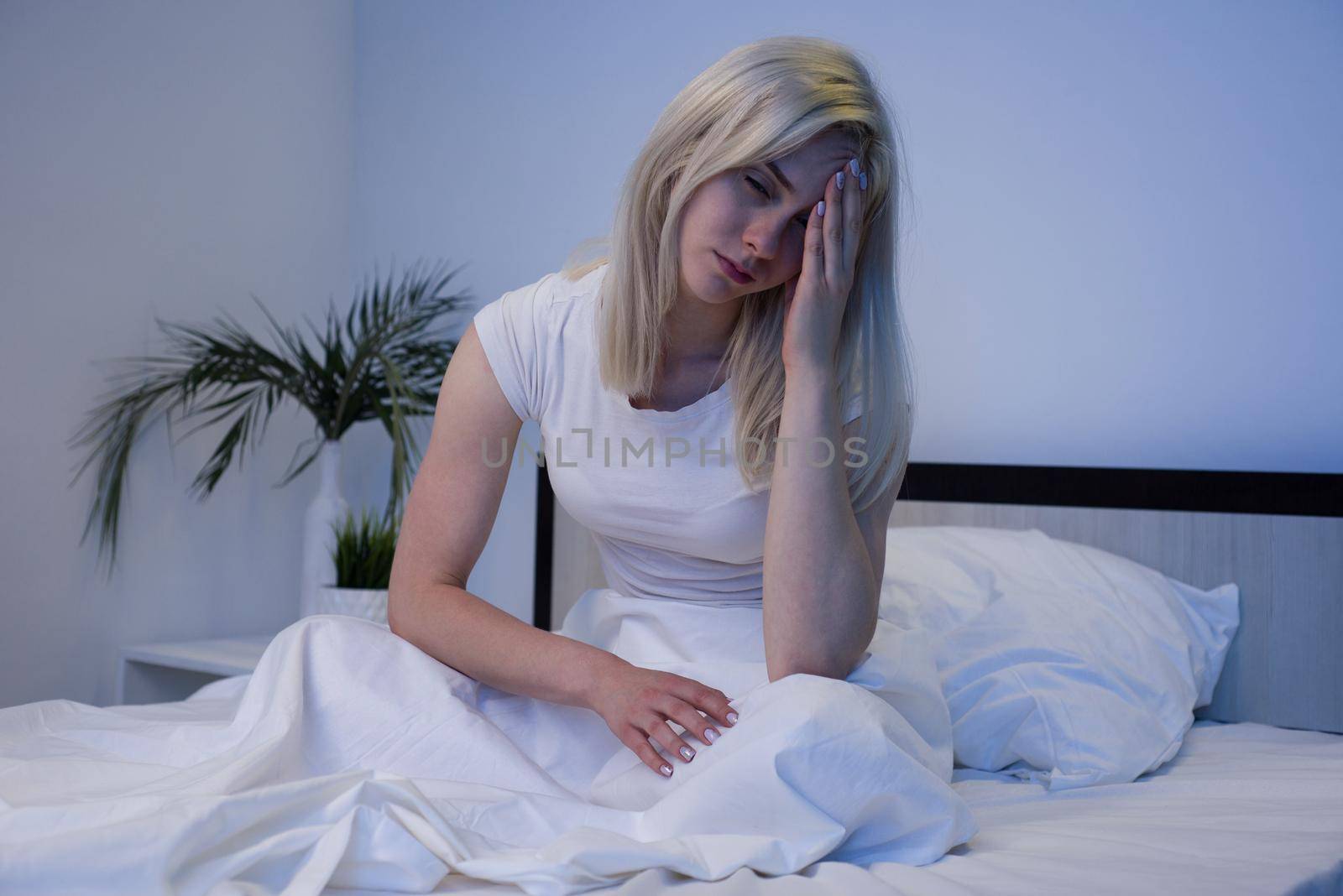 Depressed woman awake in the night, she is exhausted and suffering from insomnia - Image