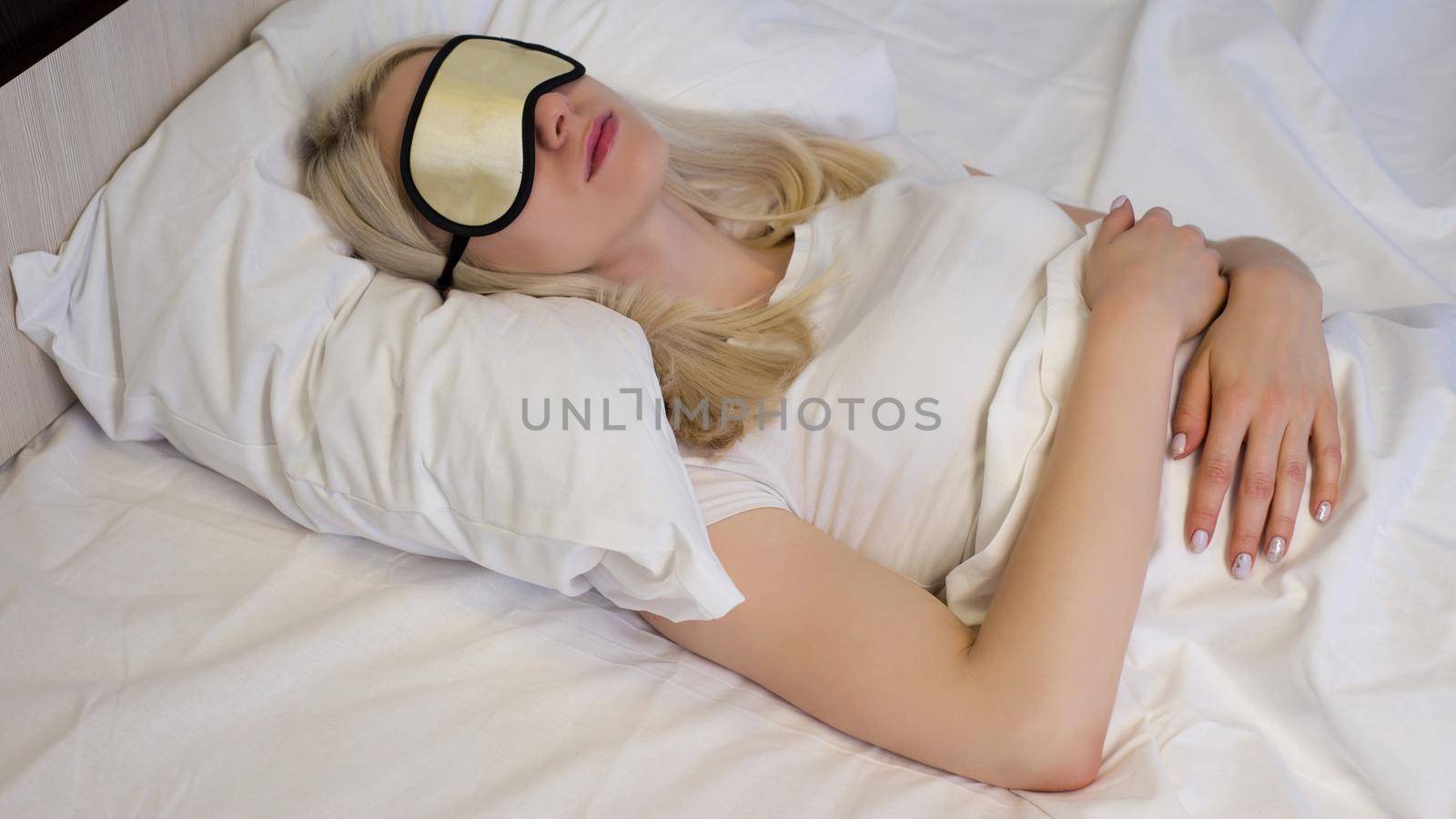 Young beautiful woman sleeping in bed with eye mask - Image