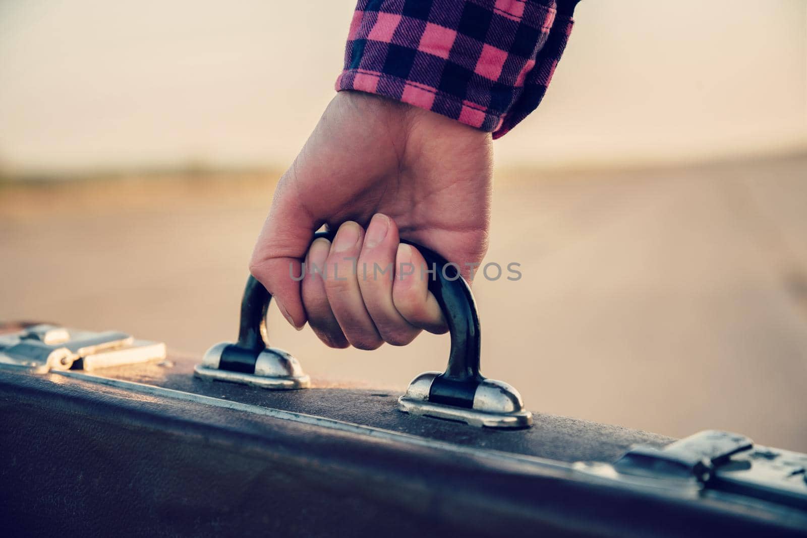 Female hand with suitcase by alexAleksei