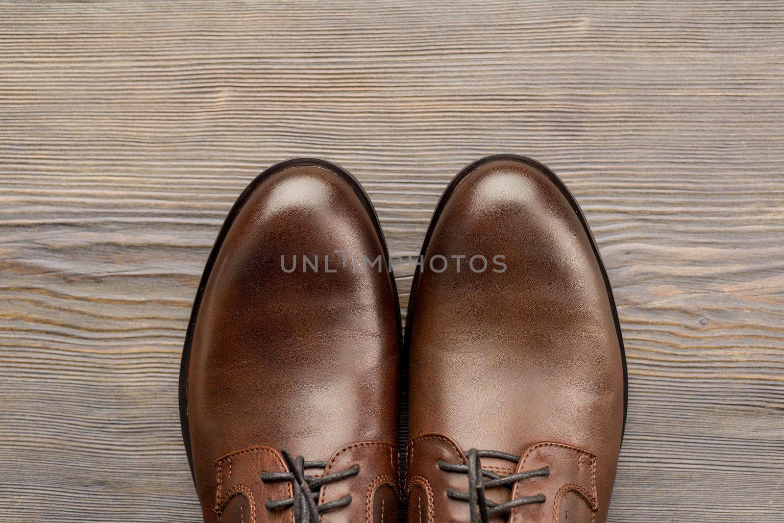 Fashionable men's classic brown shoes on a wooden background - image