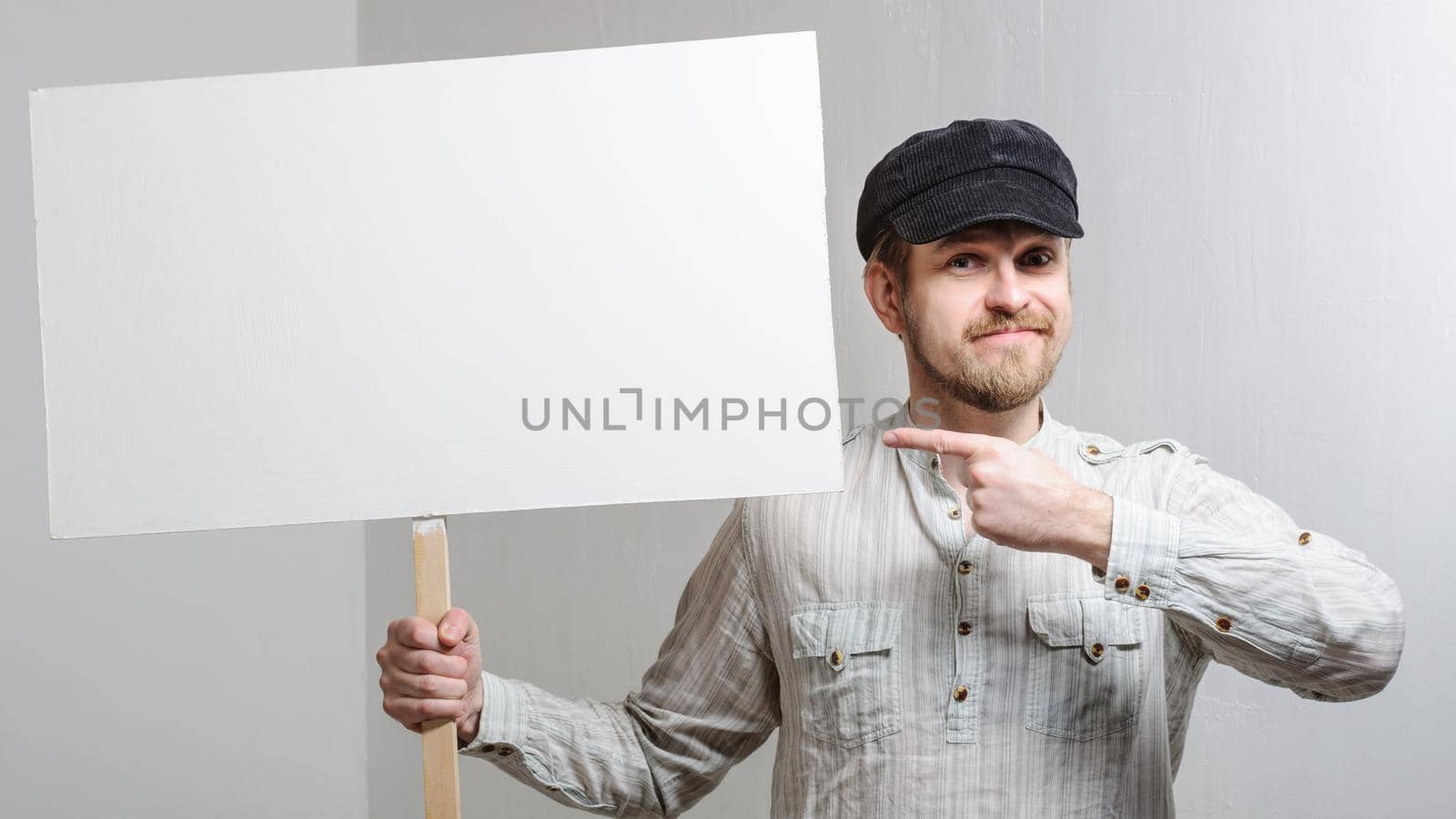 Angry protesting worker with blank protest sign.