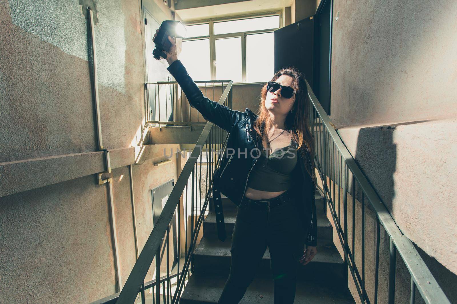 Women independence and feminism concept - Girl on dark stairs in military style