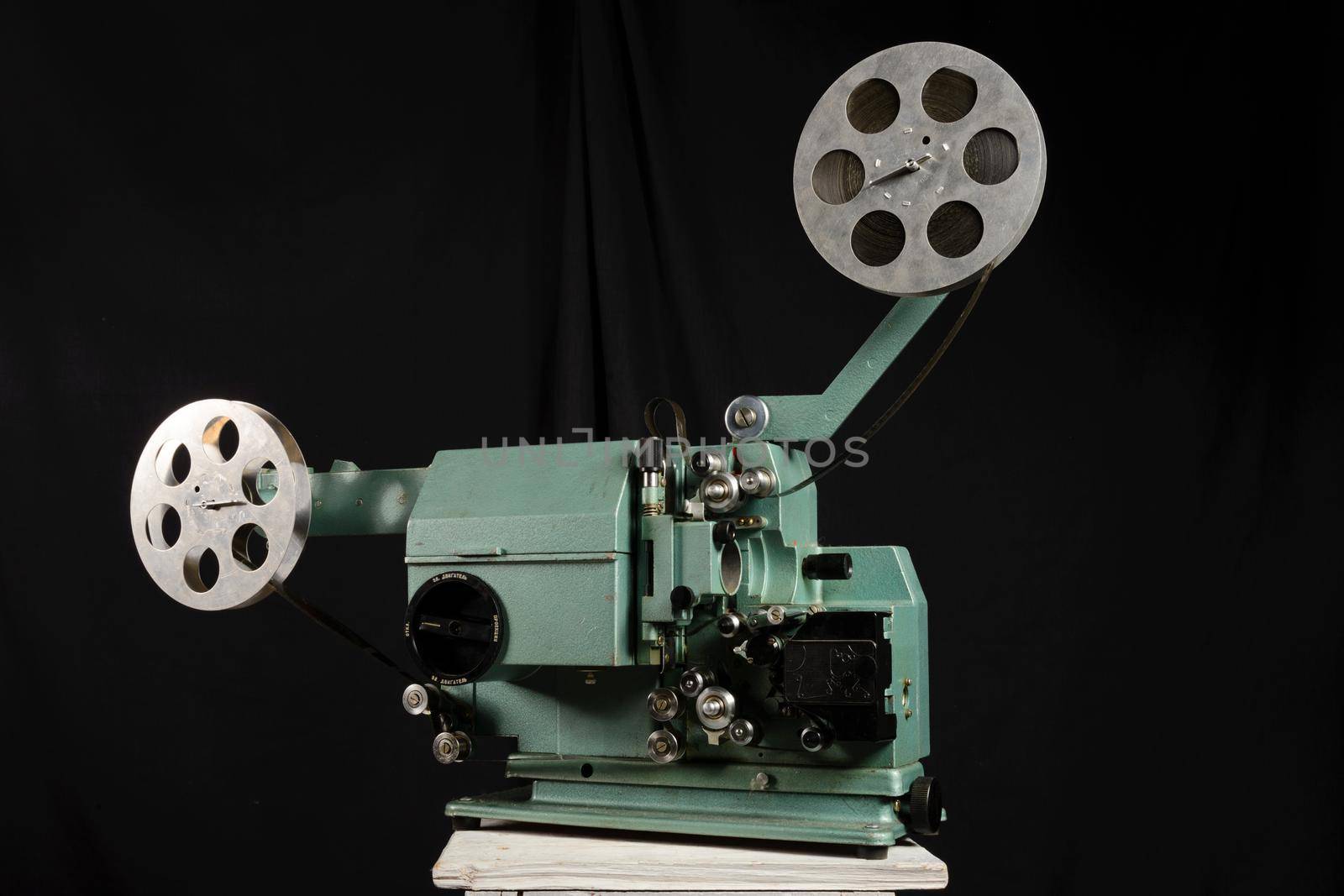 Movie projector with the film on the white background