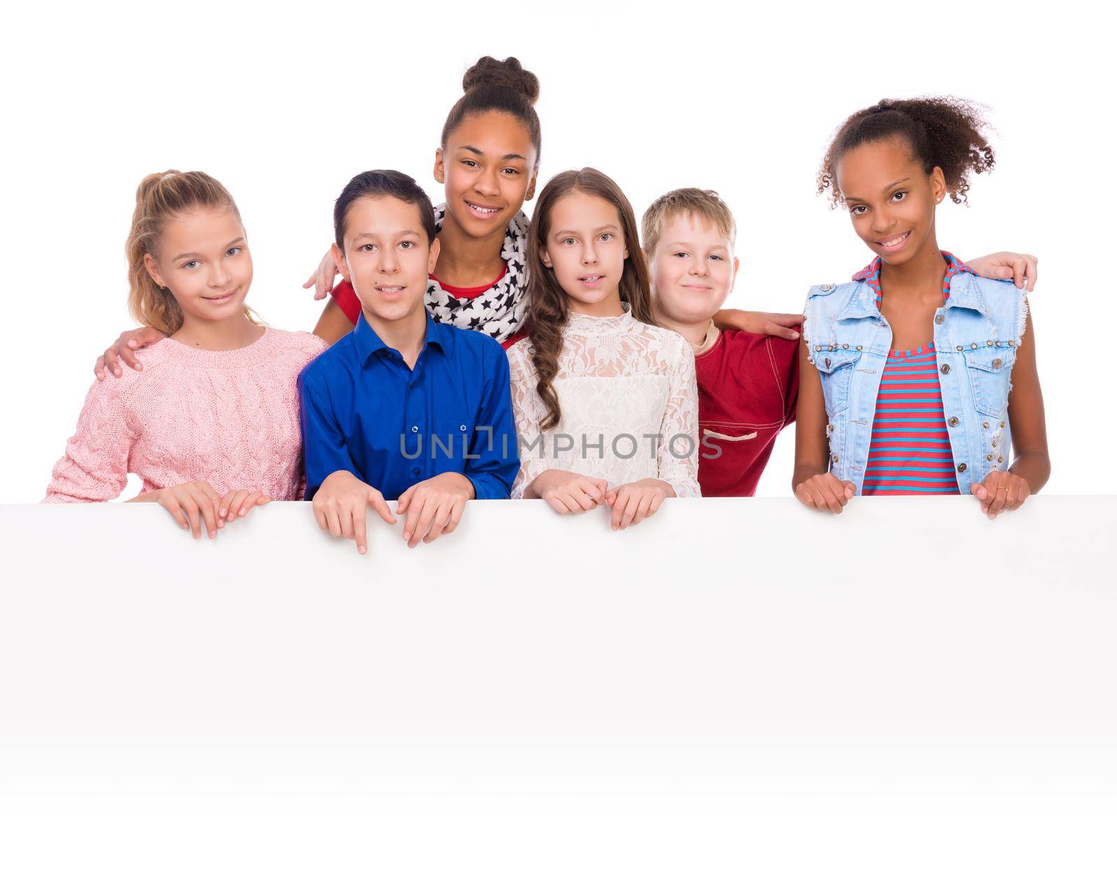 joyful teenagers with thumbs up holding an empty blank isolated on white background