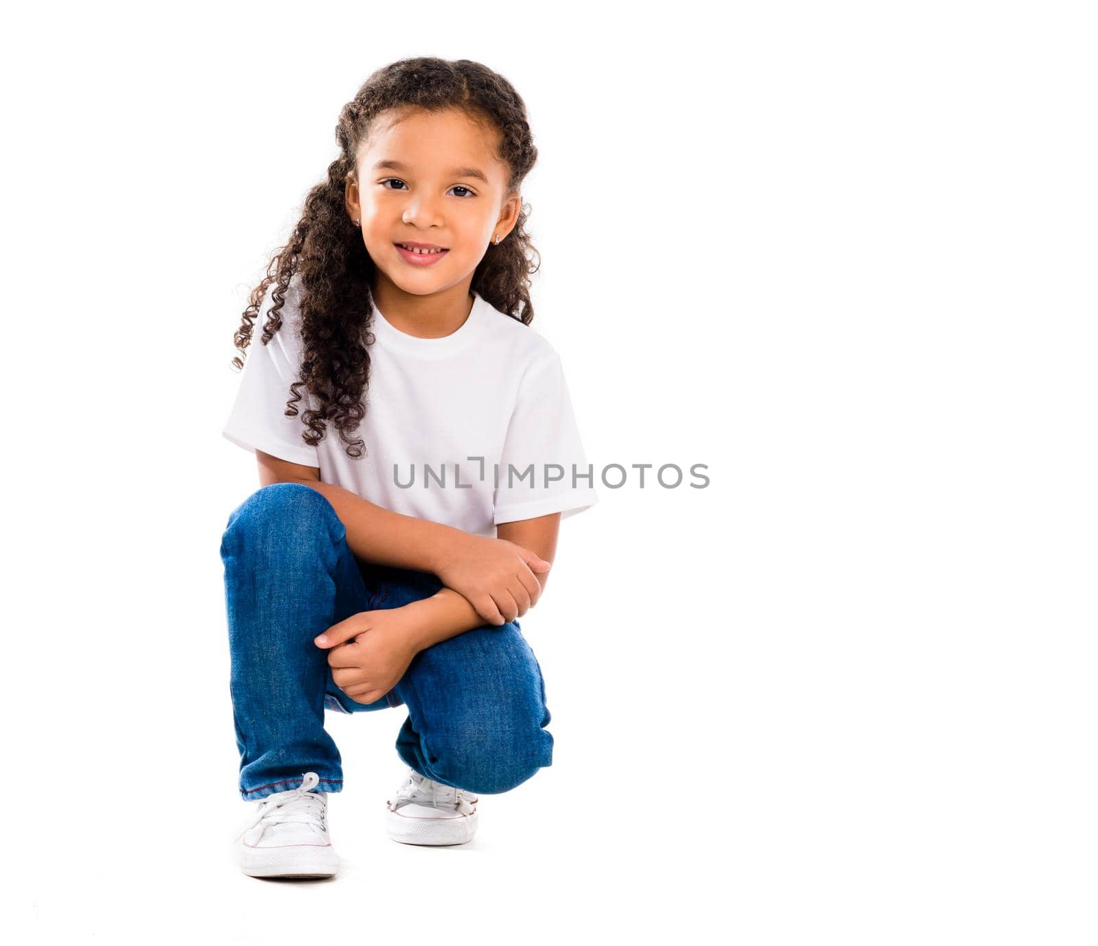 smiling little cute girl knelted on one knee isolated on white backgorund