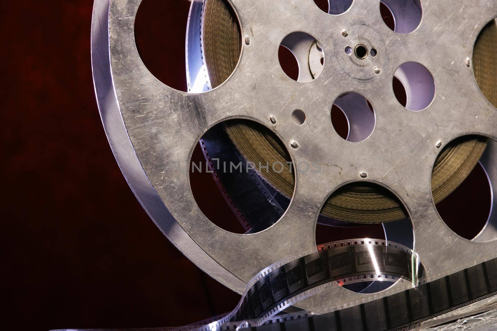 35 mm film reel with dramatic lighting on a dark background - image