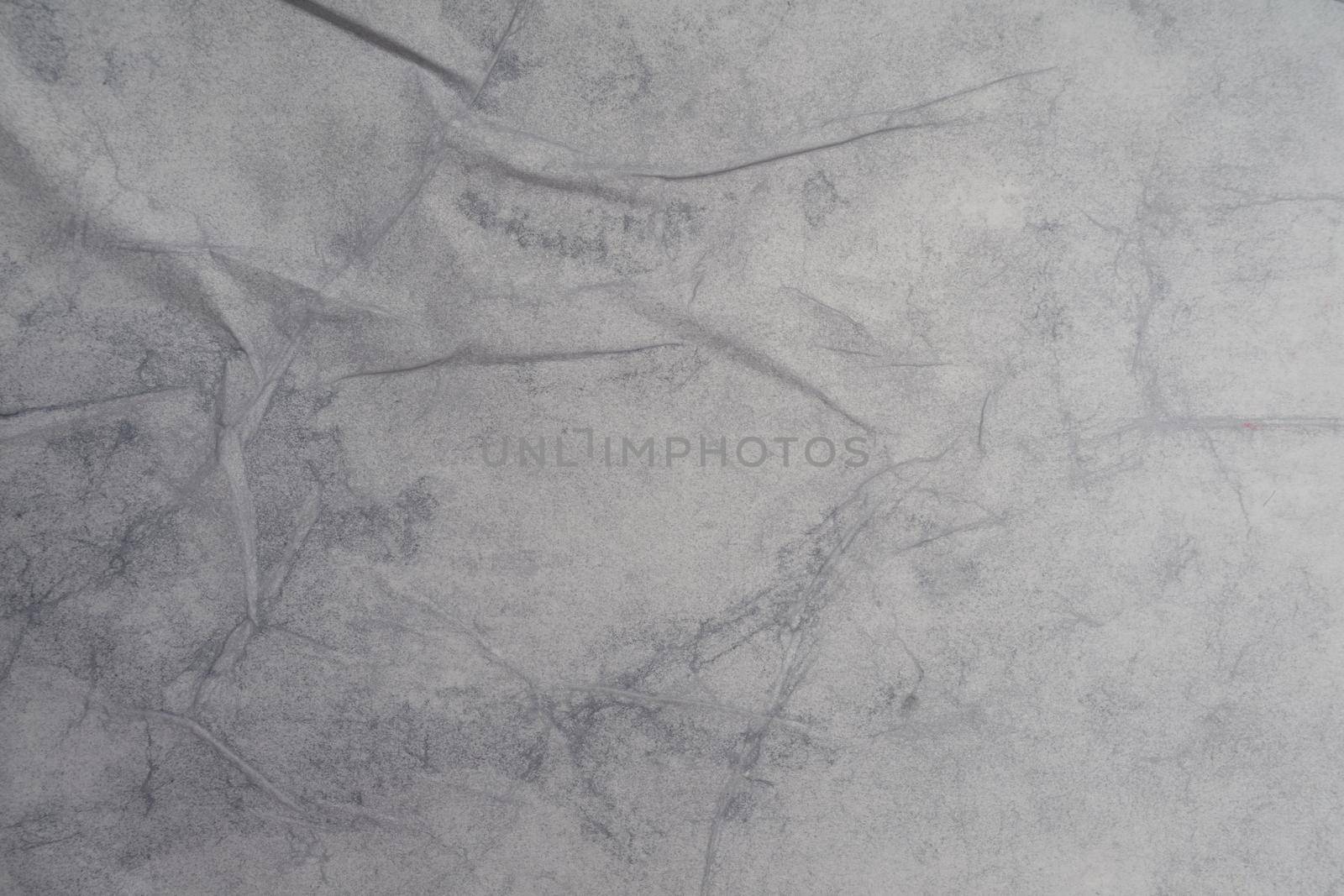 Texture of wet white folded paper on an outdoor poster wall, crumpled paper background. - image