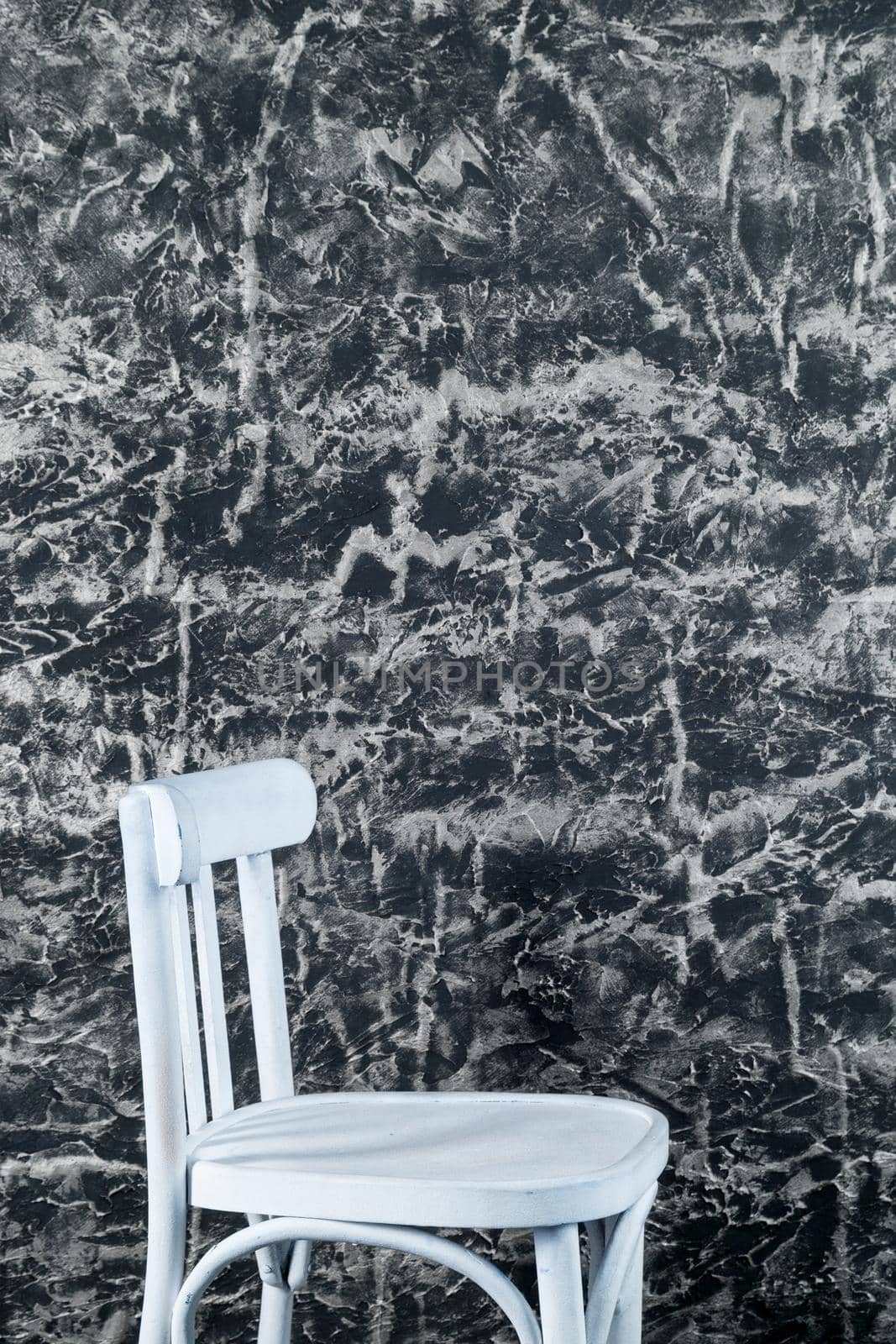White chair near Texture decorative Venetian stucco wall
