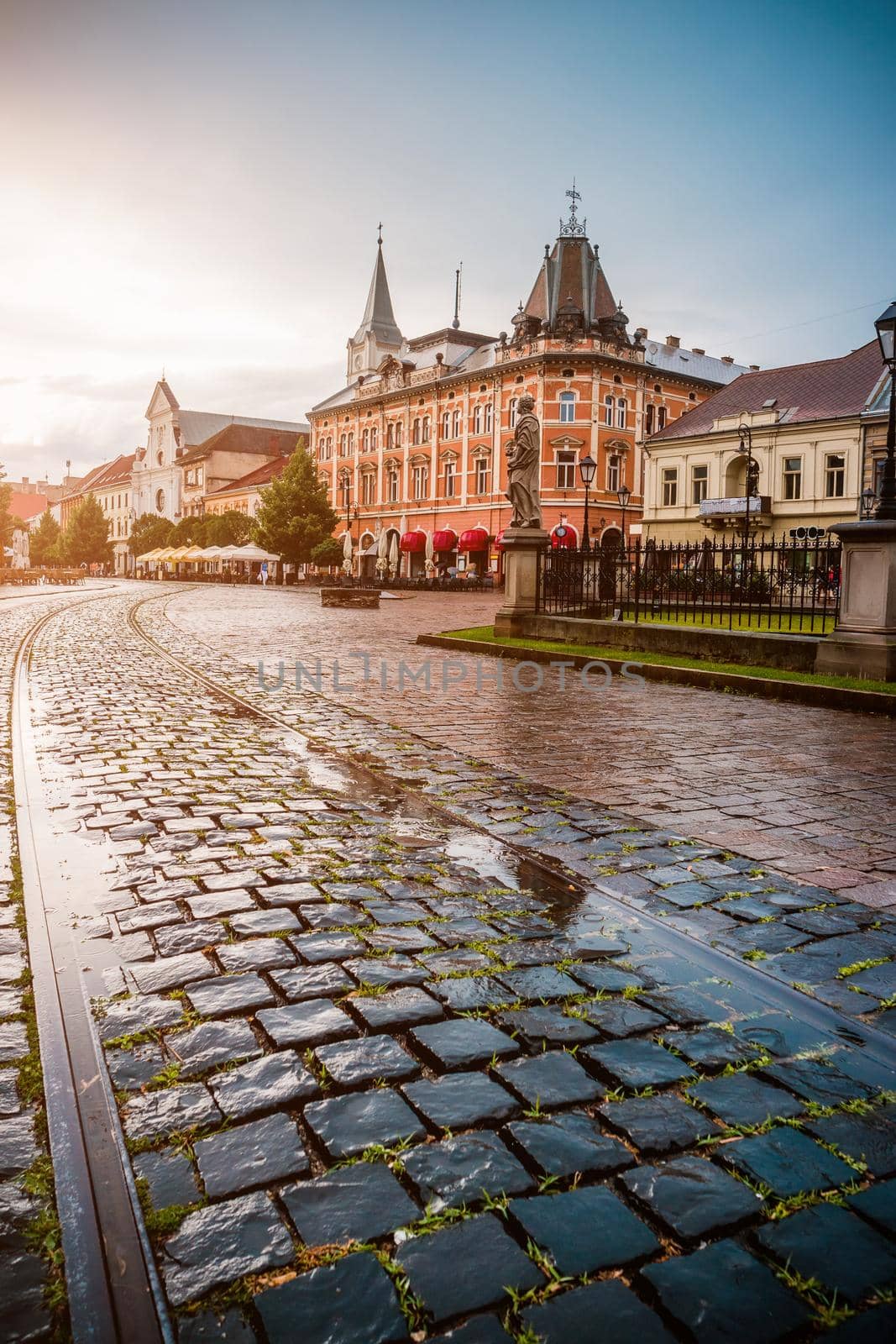 central square in Kosice with tram rails and paving stone after rain