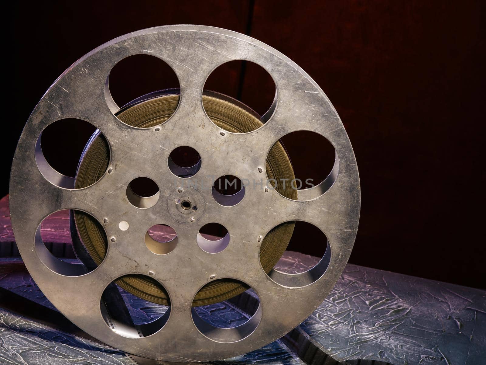 35 mm film reel with dramatic lighting on a dark background - image