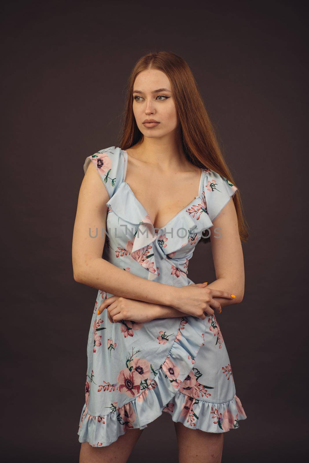 Young attractive woman posing in the studio. A full-lipped girl has problems with skin on her face and body, disease of psoriasis. She does not lose heart and lives a full life wants to become a model