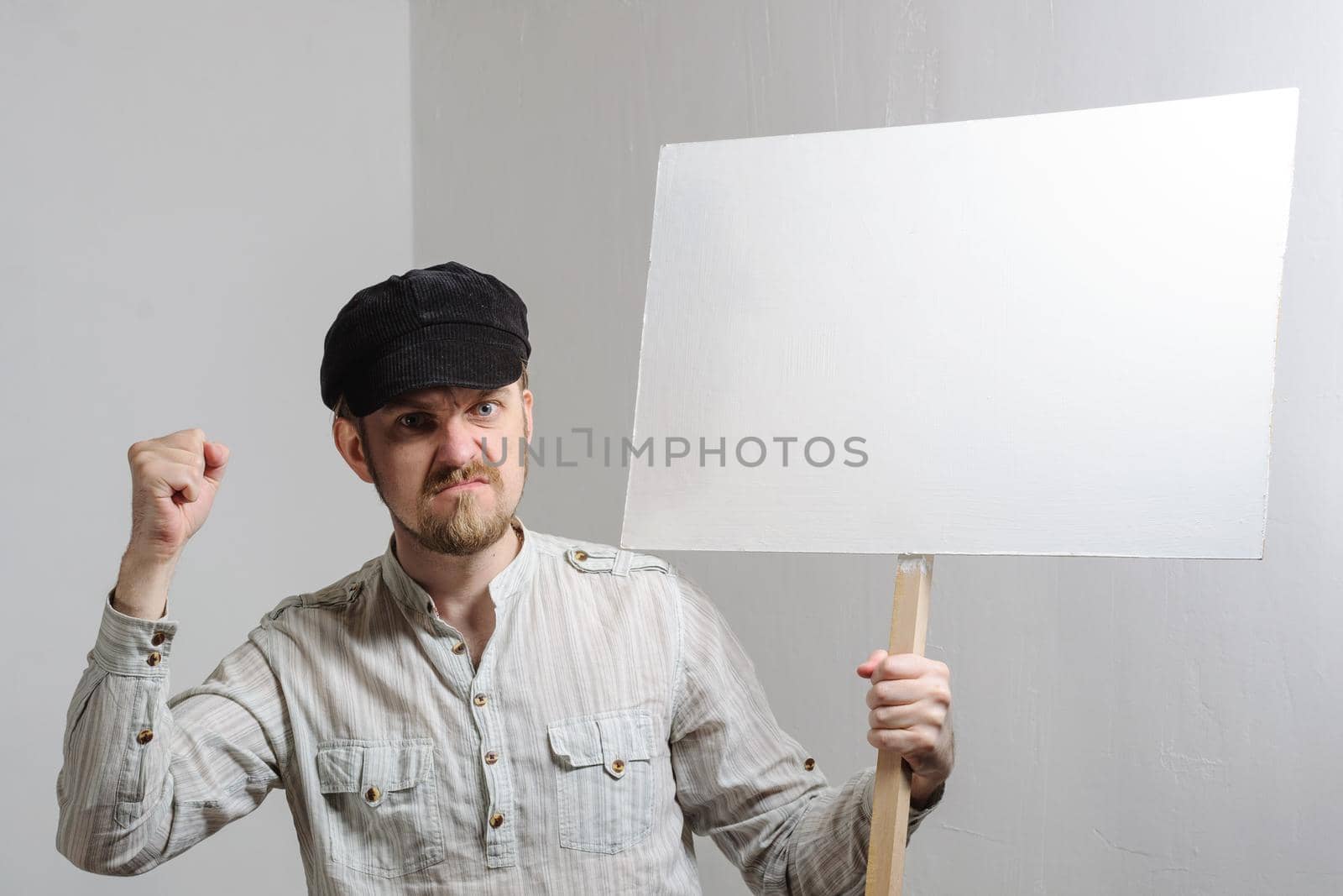 Angry protesting worker with blank protest sign.