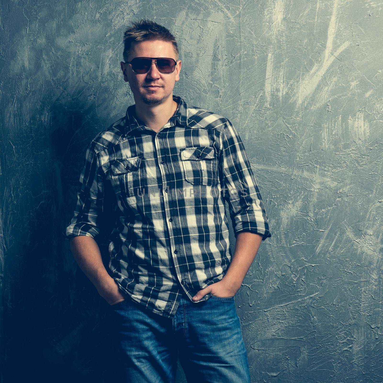 portrait of the man in sunglasses and plaid shirt