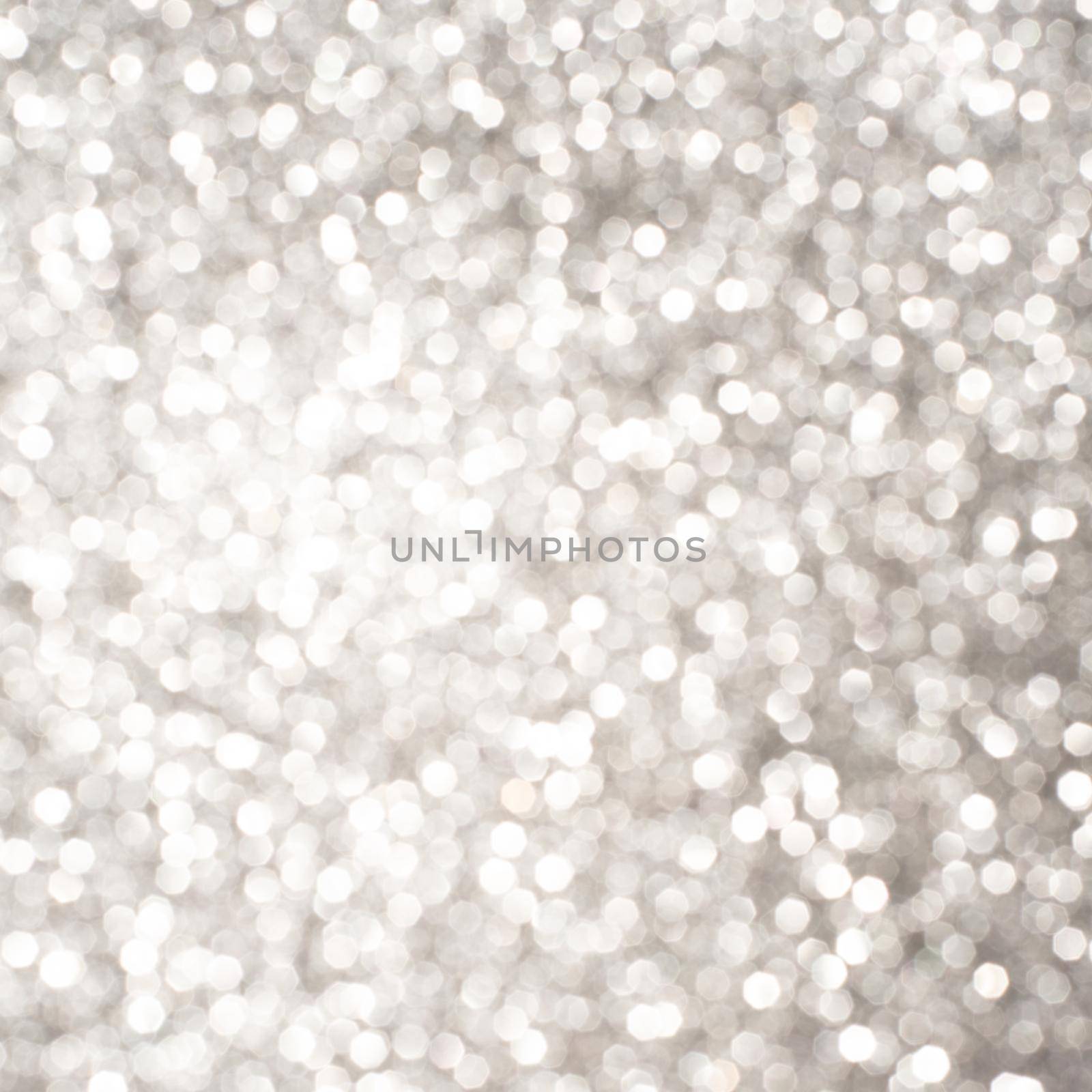 Silver Sparkling Lights Festive background with texture. Abstract Christmas twinkled bright bokeh defocused and Falling stars. Winter Card or invitation