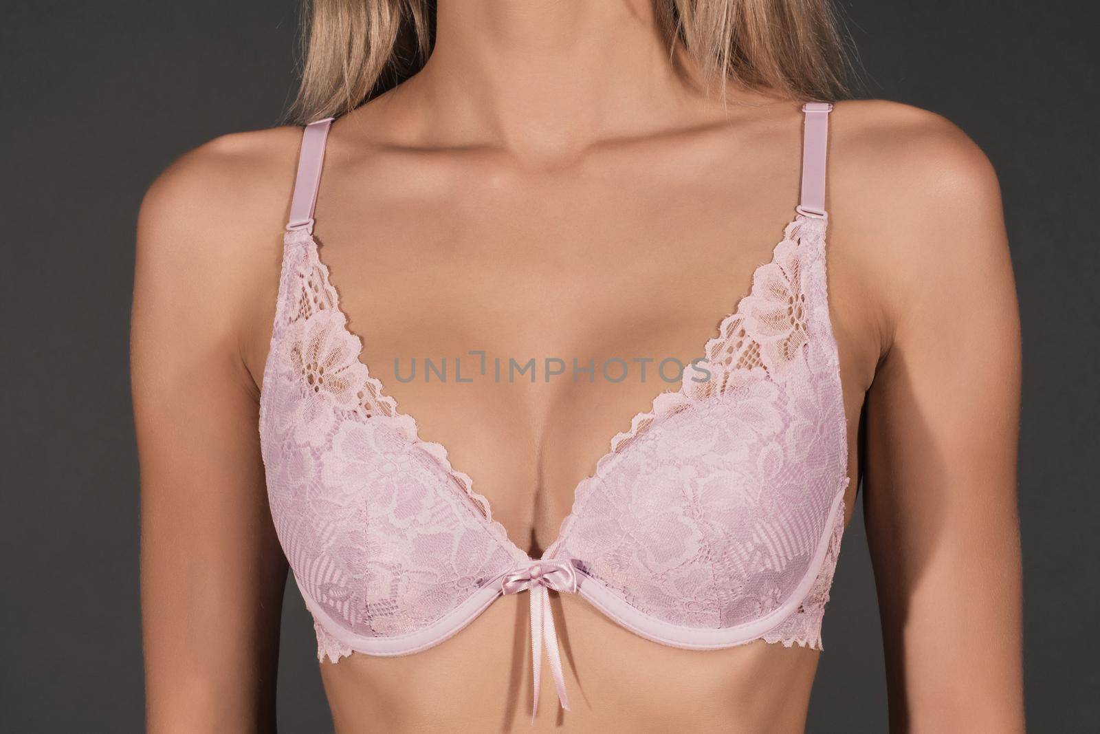 close up of sexy female breast in lilac lace bra
