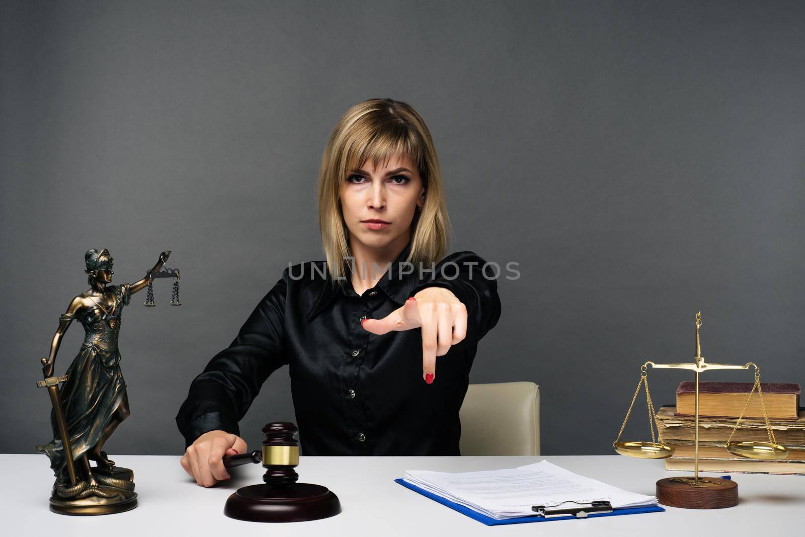 A young fair woman judge works in her office. - image