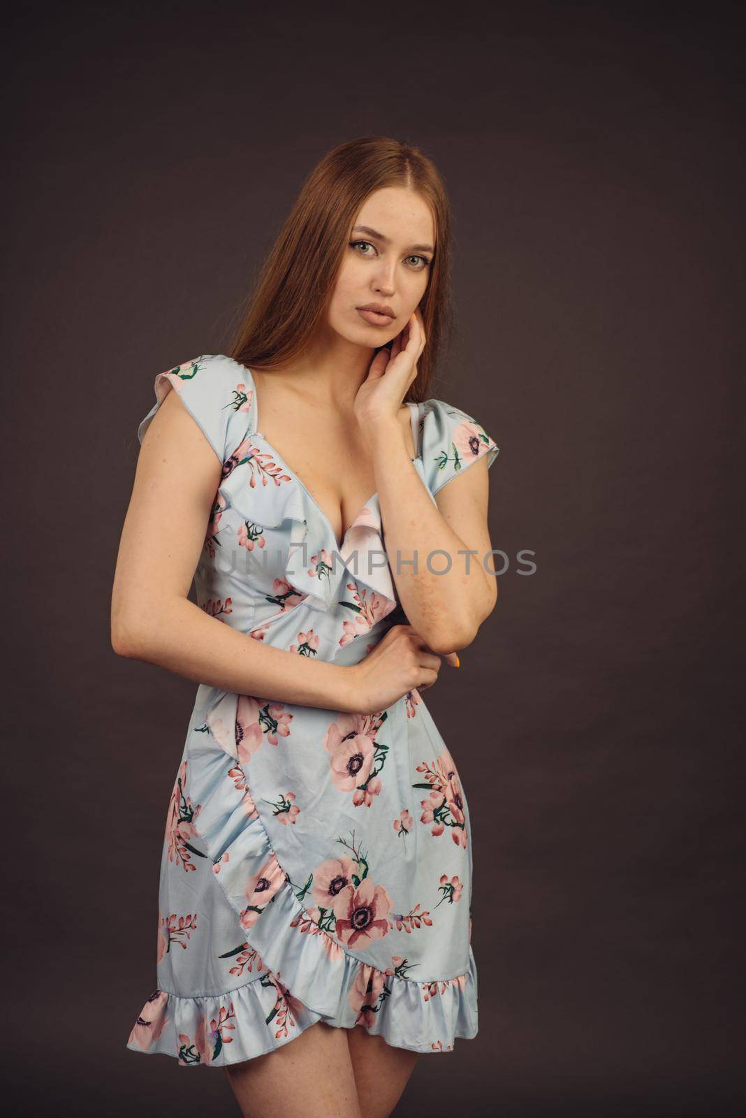 Young attractive woman posing in the studio. A full-lipped girl has problems with skin on her face and body, disease of psoriasis. She does not lose heart and lives a full life wants to become a model