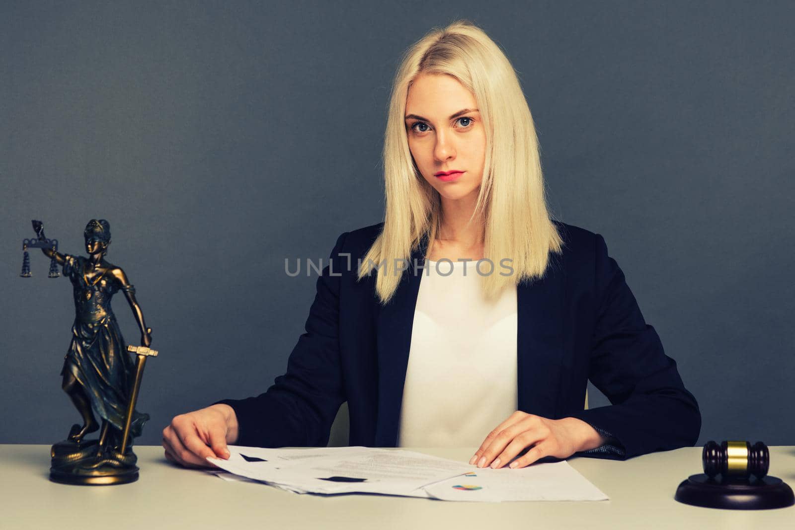 Female lawyer working at table in office - image toned
