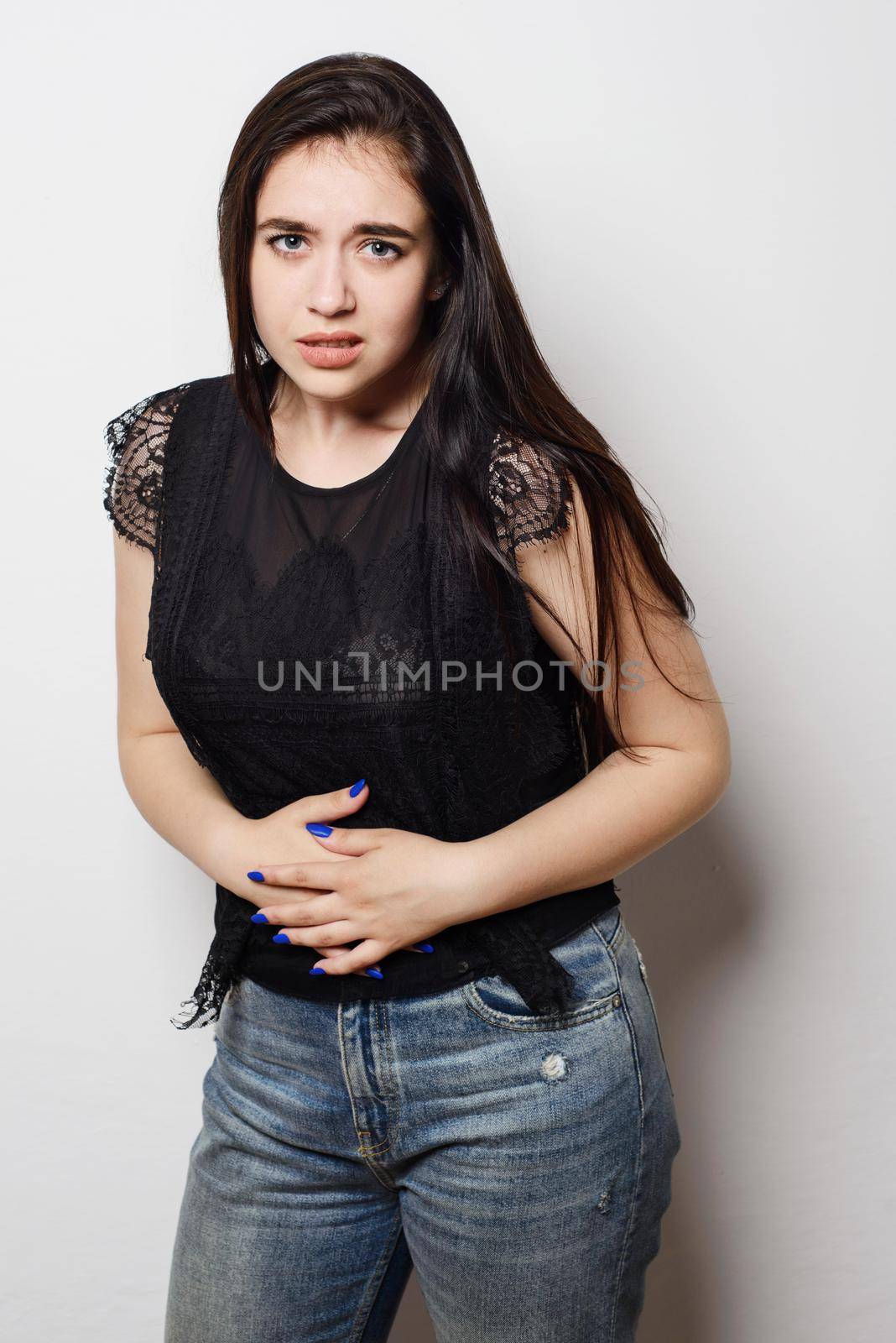 Woman having stomach pain. Isolated on white background.