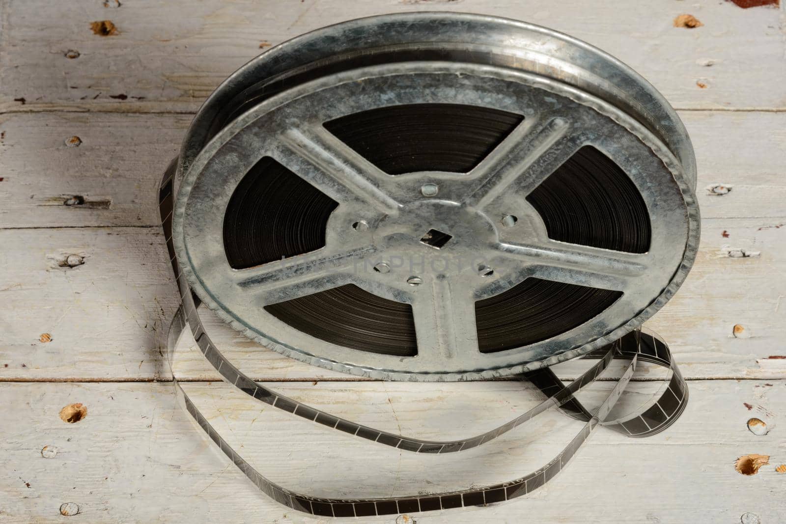 Movie reel on a white wooden background