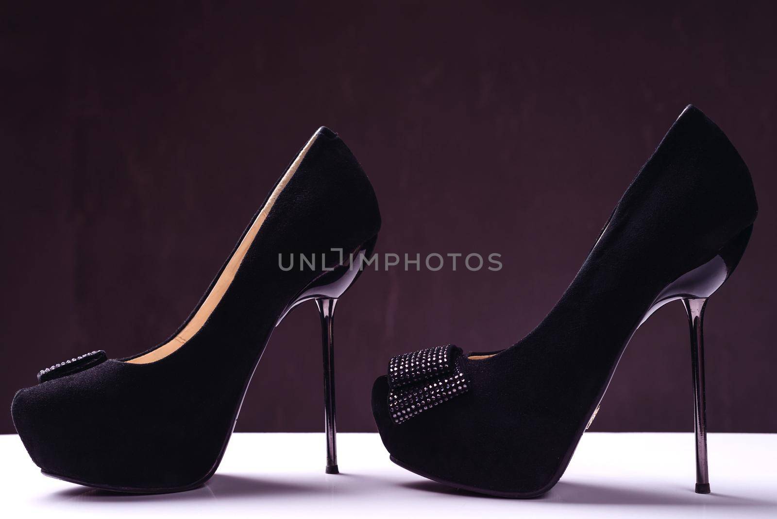 Pair of elegant high heel shoes on background. Black footwear.