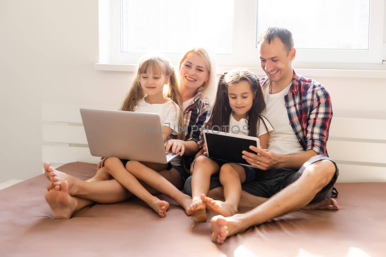 Animated family buying online lying down on bed at home