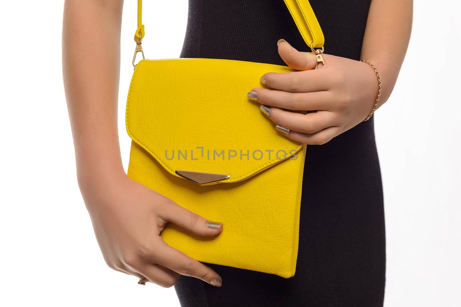The fashionable young woman holding yellow handbag white background.