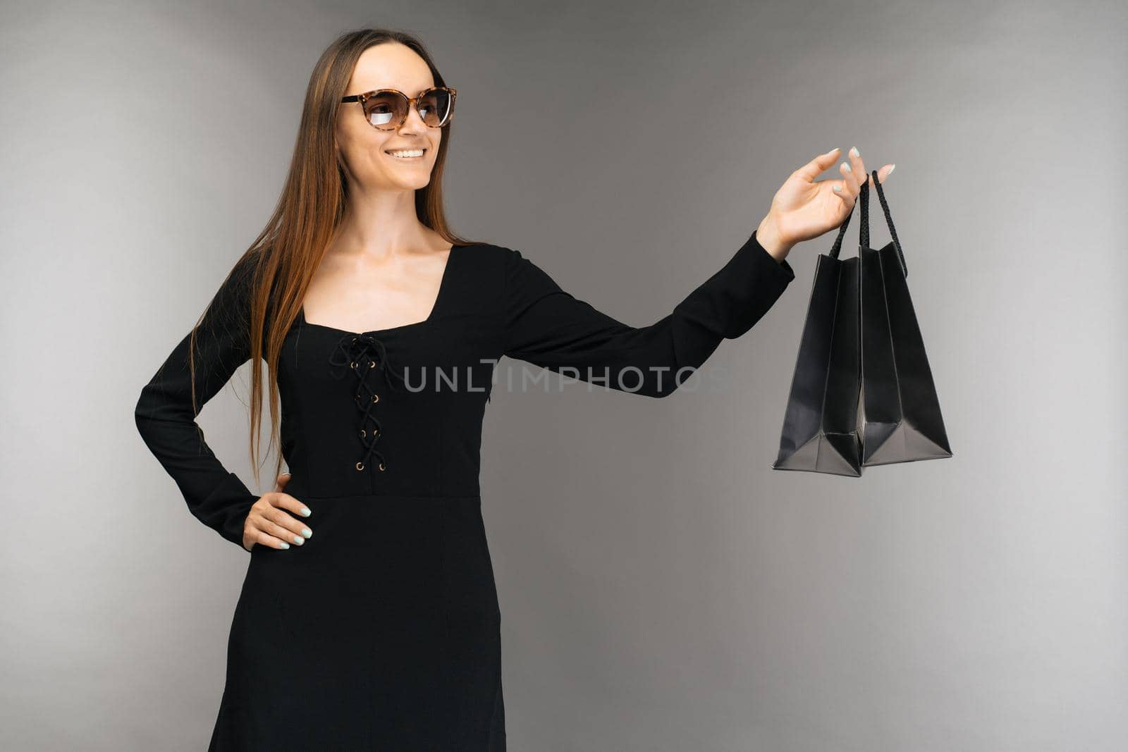 Black friday sale concept. Shopping woman holding bag isolated on background in holiday - Image