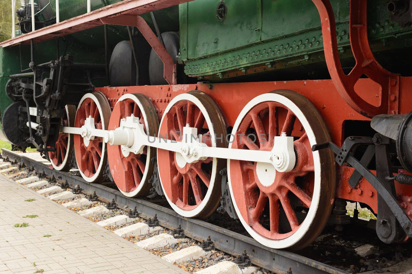 Traction wheel of old steam locomotive on the rails.