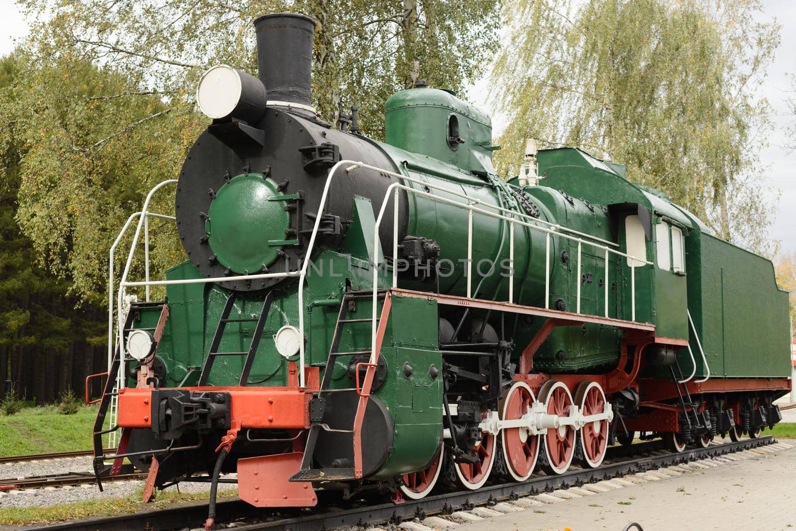 Side view of old green, steam locomotive.