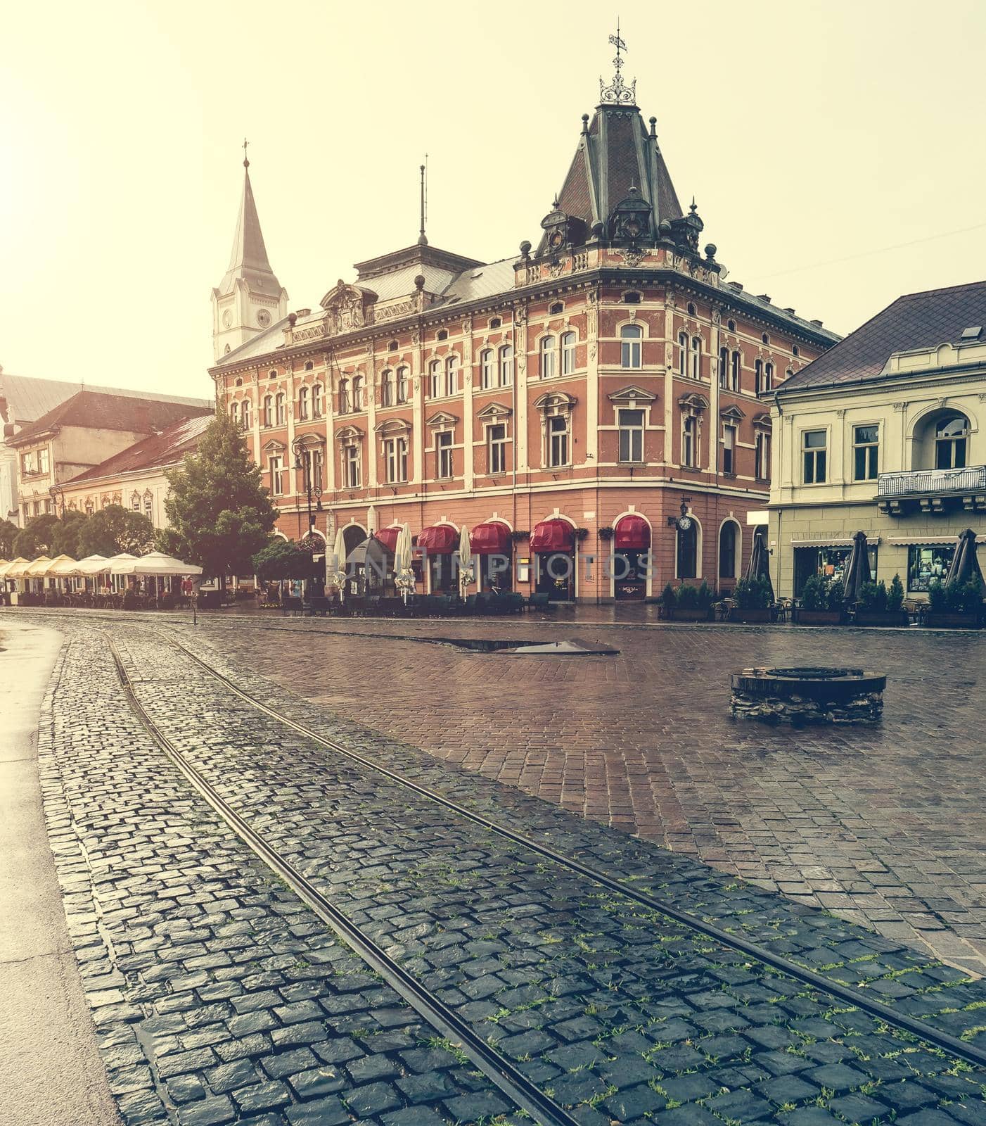 central square in Kosice with tram rails after rain by GekaSkr